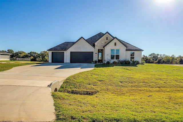 french country inspired facade featuring a front yard and a garage