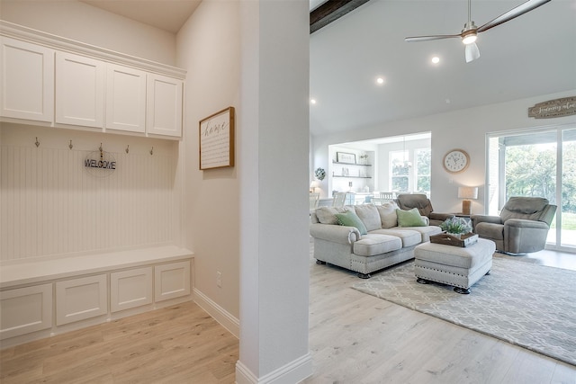 interior space featuring beam ceiling, ceiling fan, light hardwood / wood-style flooring, and high vaulted ceiling