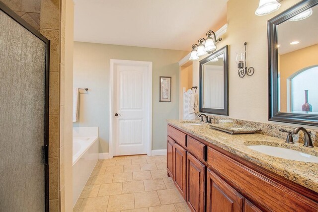 bathroom featuring independent shower and bath, tile patterned flooring, and vanity