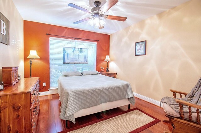 bedroom with ceiling fan and hardwood / wood-style flooring