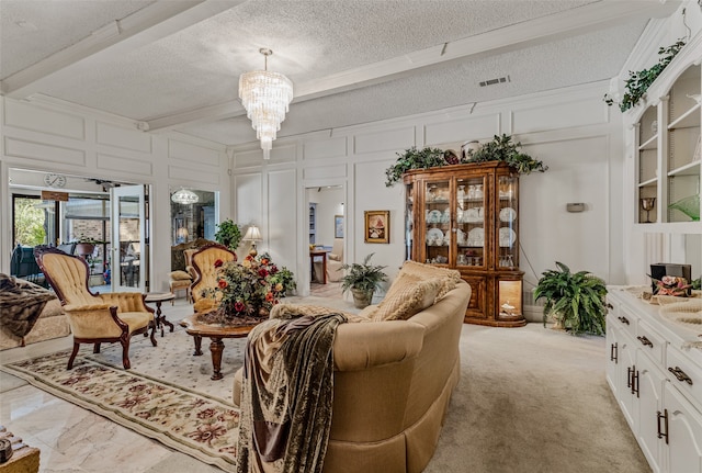 living room featuring a textured ceiling, light colored carpet, and a notable chandelier