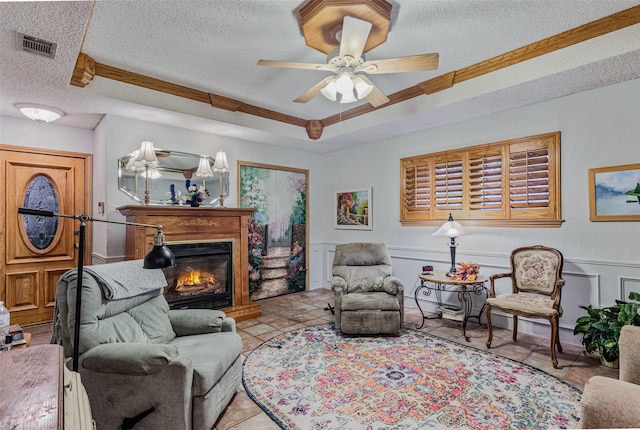 tiled living room featuring ceiling fan and a textured ceiling