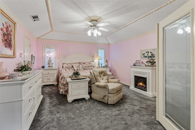 bedroom with a textured ceiling, ceiling fan, lofted ceiling, and dark colored carpet