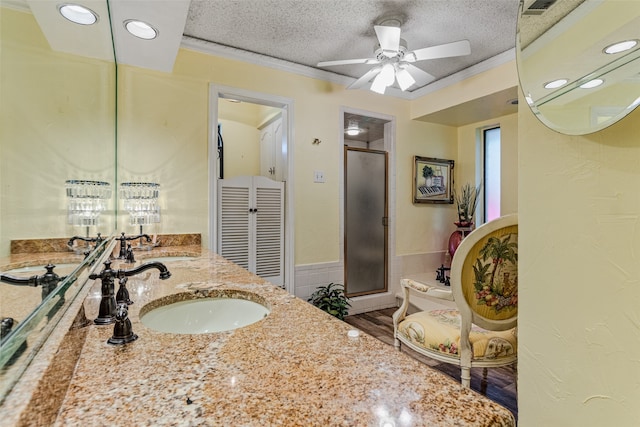 bathroom featuring an enclosed shower, a textured ceiling, ceiling fan, crown molding, and hardwood / wood-style flooring