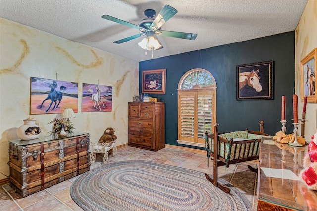 interior space featuring ceiling fan and a textured ceiling