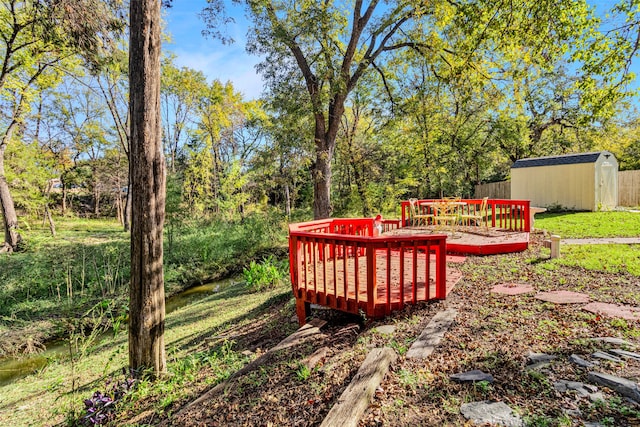 view of yard with a storage unit and a wooden deck