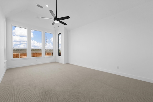 carpeted empty room with ceiling fan and vaulted ceiling