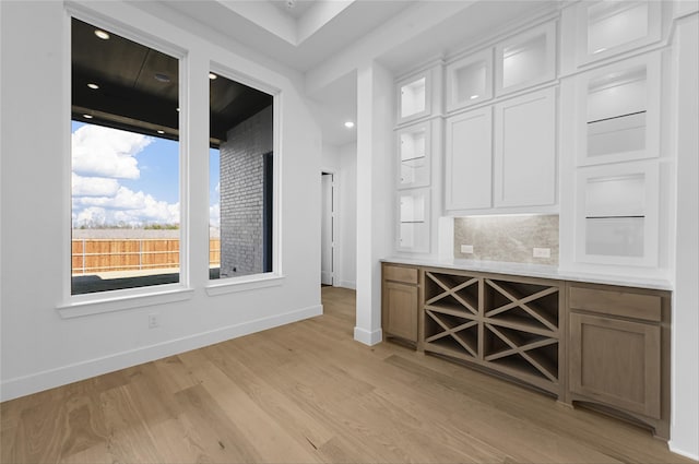 unfurnished dining area featuring light wood-type flooring