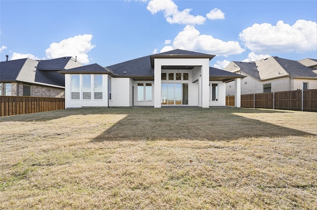 back of house with a lawn