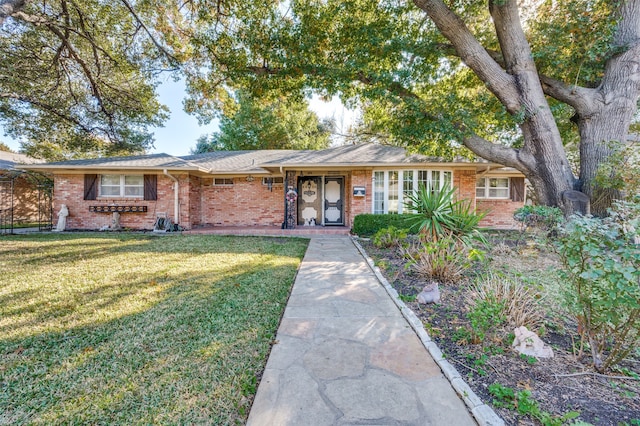 ranch-style home with a front lawn