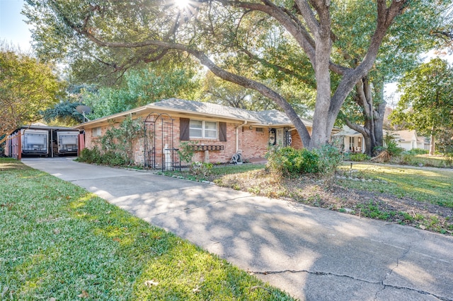 ranch-style house with a garage and a front lawn