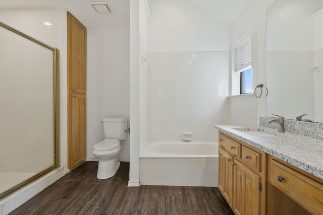 full bathroom featuring vanity, hardwood / wood-style flooring, toilet, and lofted ceiling