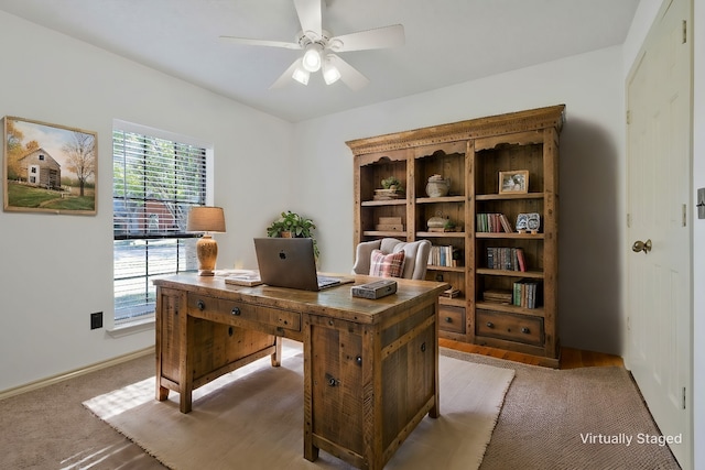 office space with ceiling fan and carpet