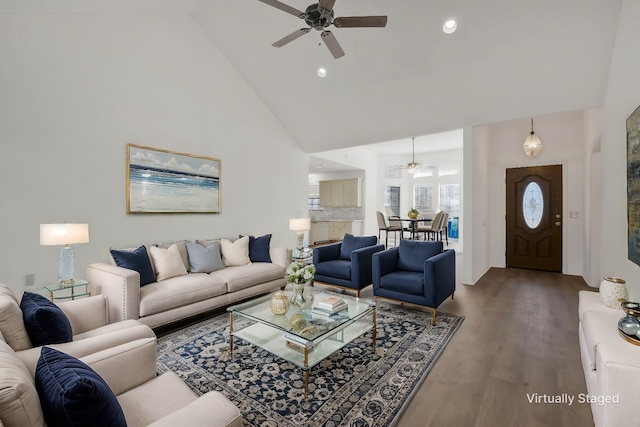 living room featuring hardwood / wood-style floors, ceiling fan, and high vaulted ceiling