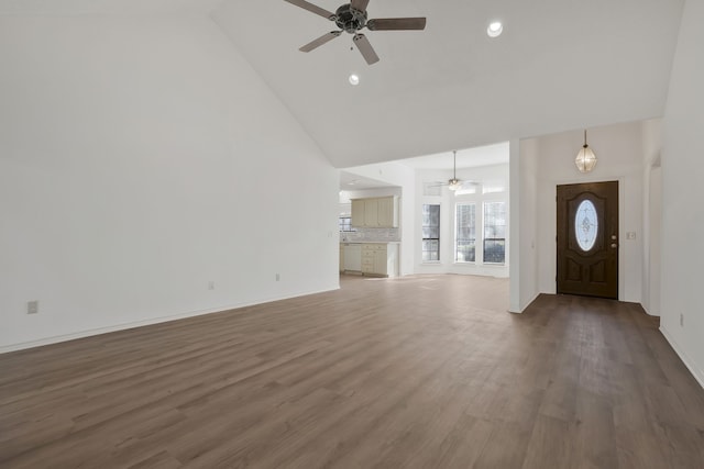 unfurnished living room with dark hardwood / wood-style floors, high vaulted ceiling, and ceiling fan