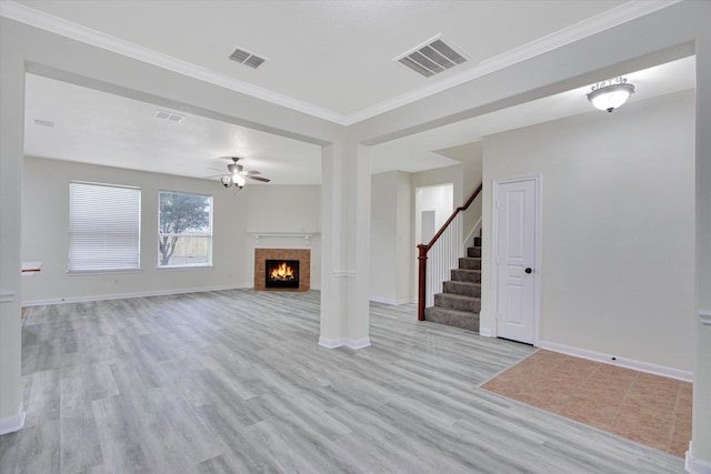 unfurnished living room featuring ceiling fan, light hardwood / wood-style floors, and ornamental molding