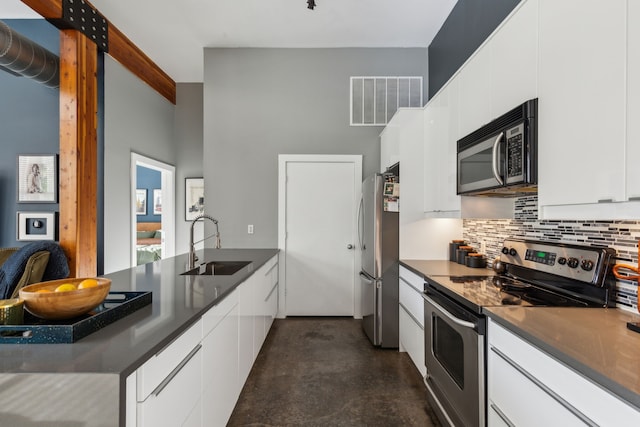 kitchen featuring white cabinets, decorative backsplash, sink, and appliances with stainless steel finishes