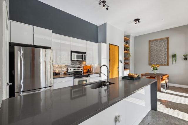 kitchen featuring white cabinetry, sink, appliances with stainless steel finishes, and tasteful backsplash