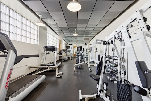 workout area featuring a paneled ceiling