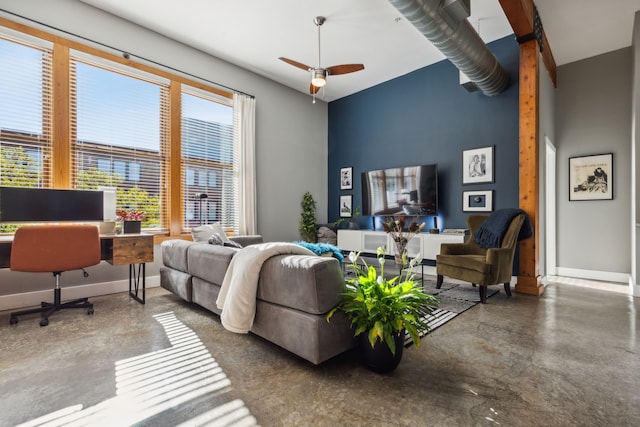 living room featuring ceiling fan and concrete floors