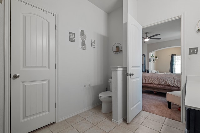 bathroom featuring tile patterned flooring, ceiling fan, and toilet