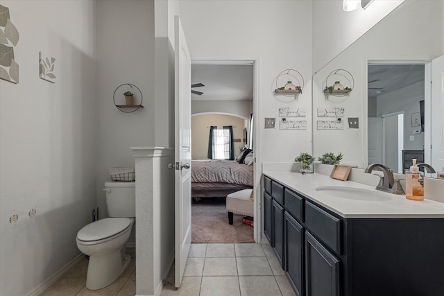 bathroom with tile patterned flooring, vanity, and toilet