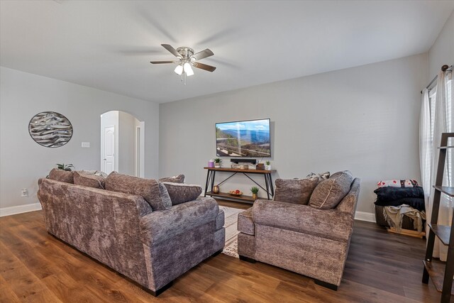 living room with ceiling fan and dark hardwood / wood-style floors