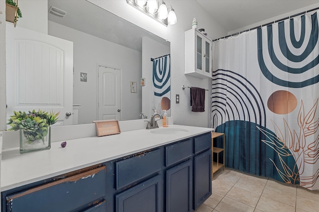 bathroom featuring tile patterned flooring and vanity