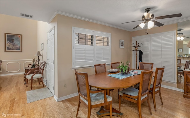 dining area with ceiling fan, light hardwood / wood-style flooring, and ornamental molding