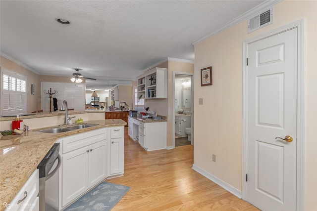 kitchen featuring crown molding, sink, light hardwood / wood-style floors, light stone counters, and white cabinetry