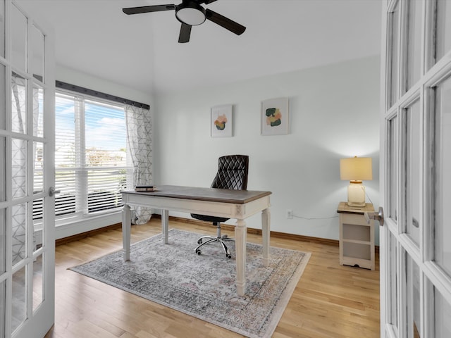 office featuring french doors, light wood-type flooring, and ceiling fan