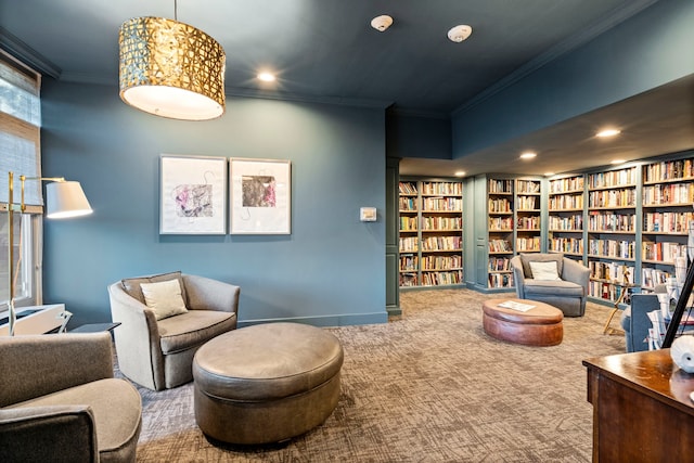 living area featuring carpet flooring, built in shelves, and ornamental molding