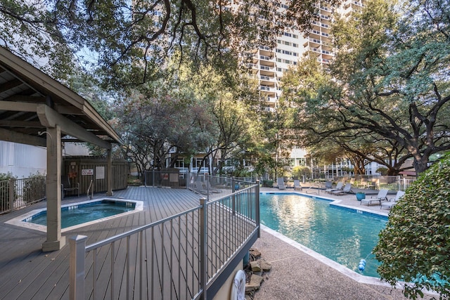 view of pool with a hot tub