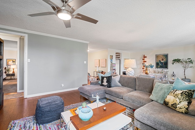 living room featuring a textured ceiling, dark hardwood / wood-style floors, ceiling fan, and crown molding