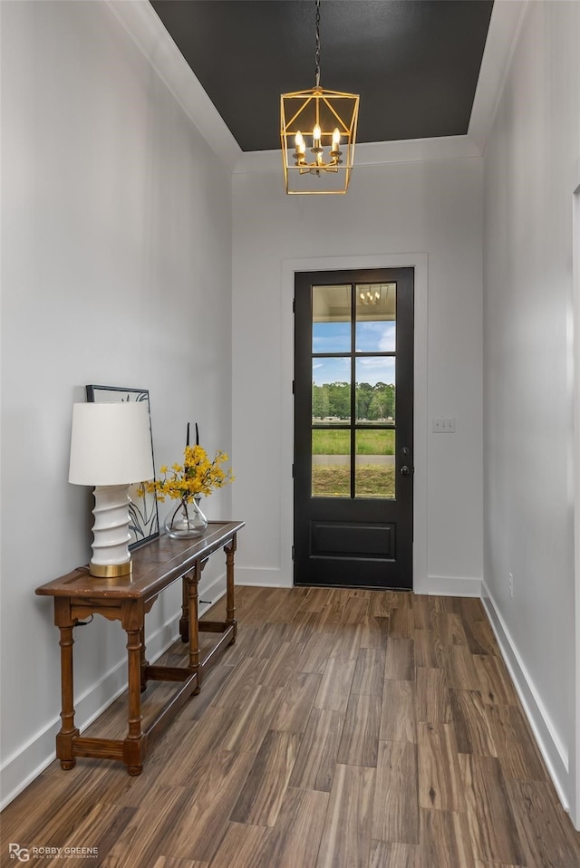 foyer entrance with a notable chandelier and dark hardwood / wood-style floors