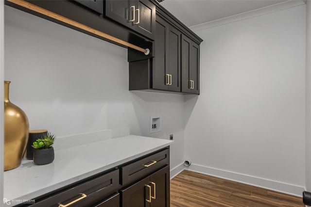 laundry area with cabinets, hookup for a washing machine, dark hardwood / wood-style flooring, crown molding, and electric dryer hookup