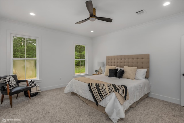 bedroom with ceiling fan, crown molding, and carpet