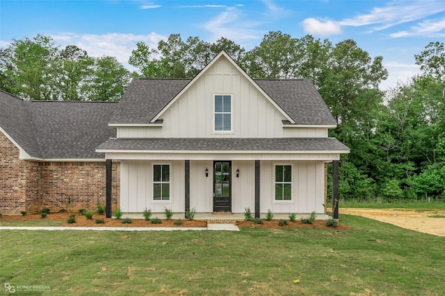 modern inspired farmhouse with a porch and a front yard