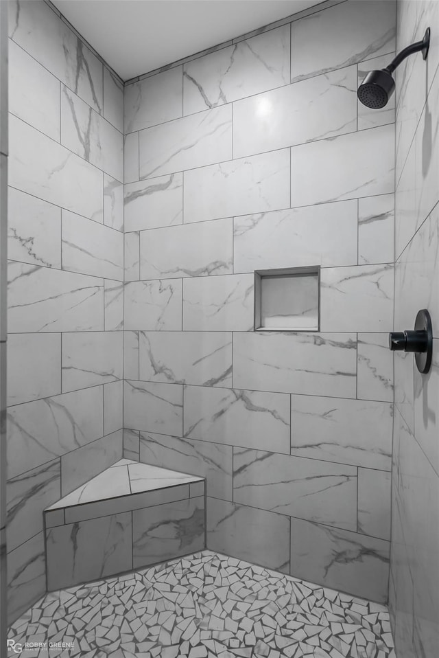 bathroom with tiled shower