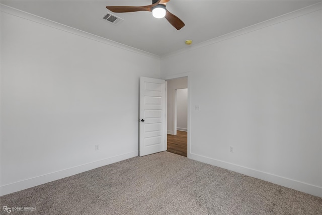 unfurnished room with crown molding, carpet floors, and ceiling fan