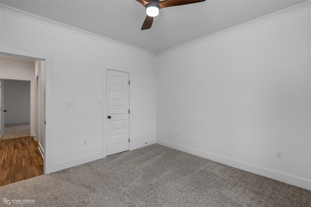 carpeted spare room featuring ceiling fan and ornamental molding