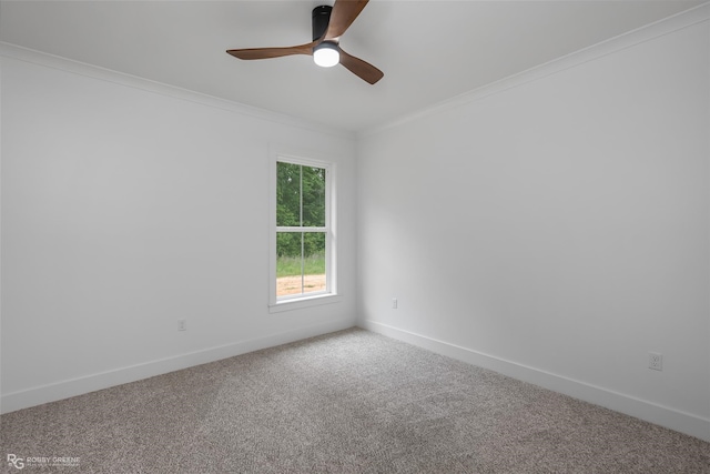 carpeted empty room with ceiling fan and crown molding