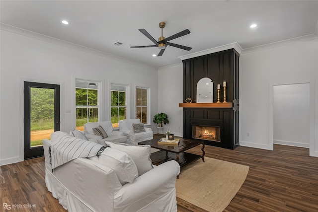 living room with ceiling fan, dark hardwood / wood-style floors, and ornamental molding