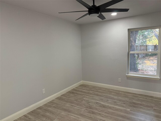 spare room featuring ceiling fan and wood-type flooring