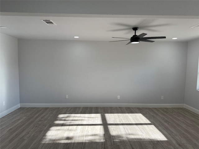 empty room with dark hardwood / wood-style floors and ceiling fan