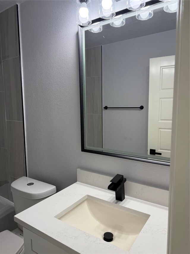 bathroom featuring vanity and toilet