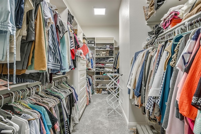 walk in closet featuring light carpet