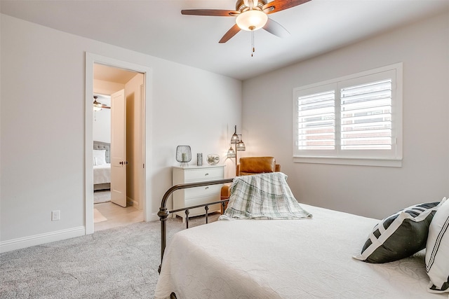 carpeted bedroom featuring connected bathroom and ceiling fan