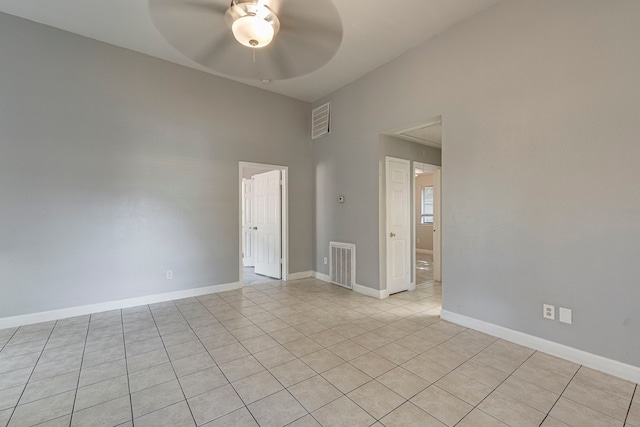 empty room with light tile patterned floors and ceiling fan