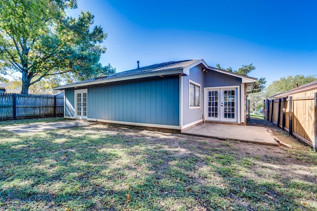 back of property featuring french doors, a patio, and a yard